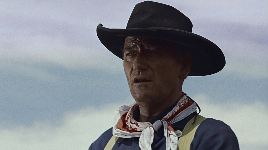 John Wayne as Ethan Edwards in his black hat.